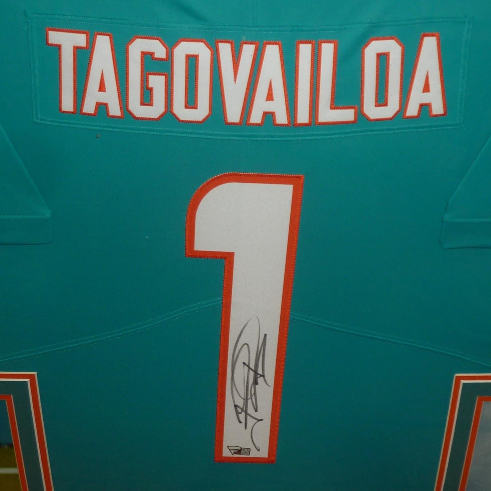 Autographed Tua Tagovailoa Miami Dolphins (Teal #1) Deluxe Framed Nike Jersey - Fanatics-Powers Sports Memorabilia