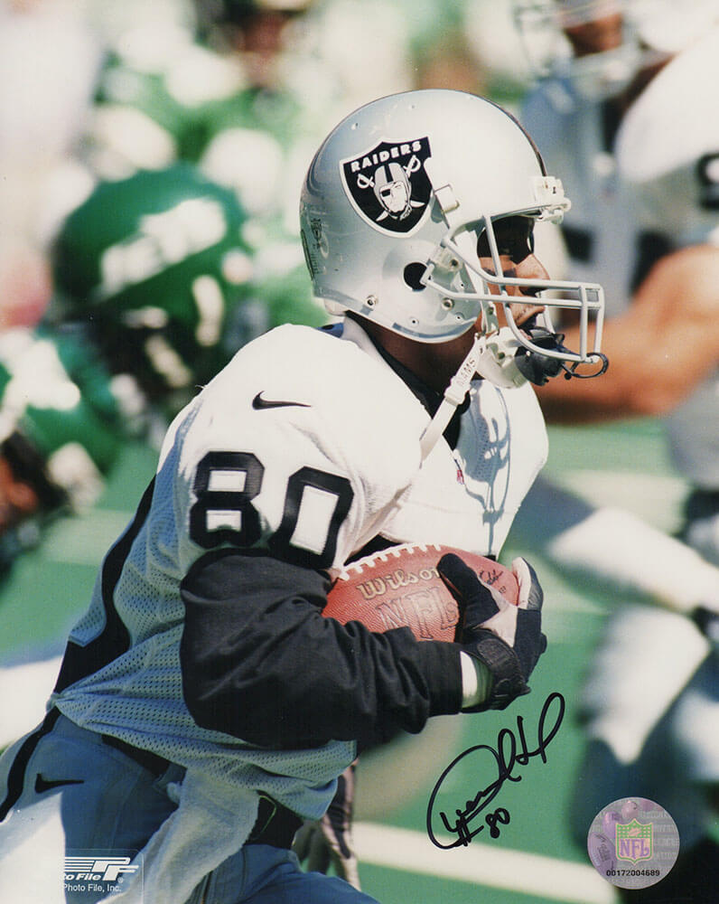 Desmond Howard Las Vegas Raiders Autographed Jersey Closeup With Football-Powers Sports Memorabilia